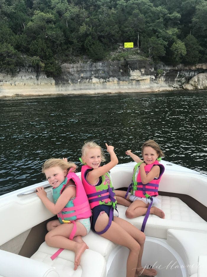 Three little girls on a white boat on Table Rock Lake as part of a list of things to do in Branson Missouri.