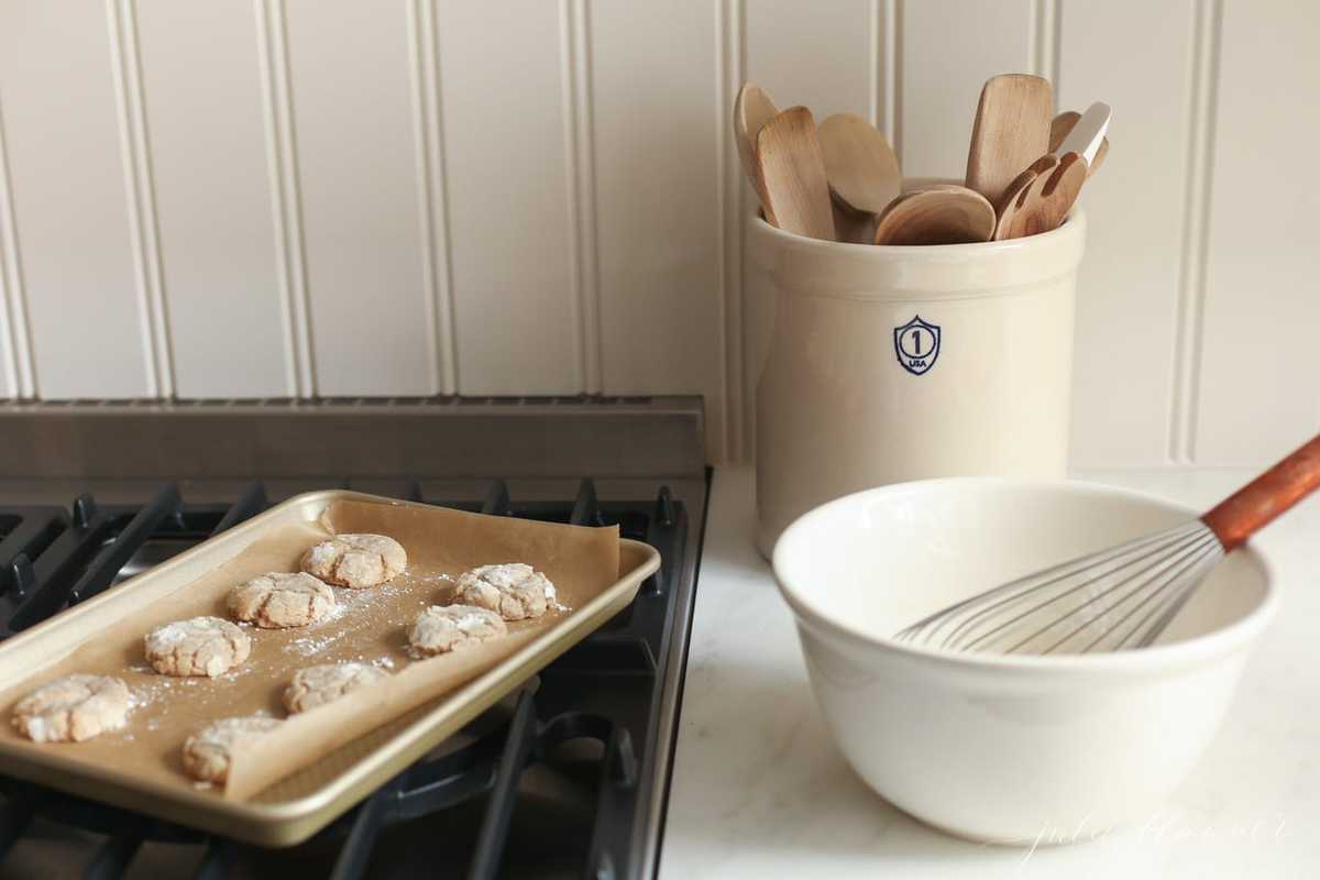 Cookies on a baking sheet on top of an oven