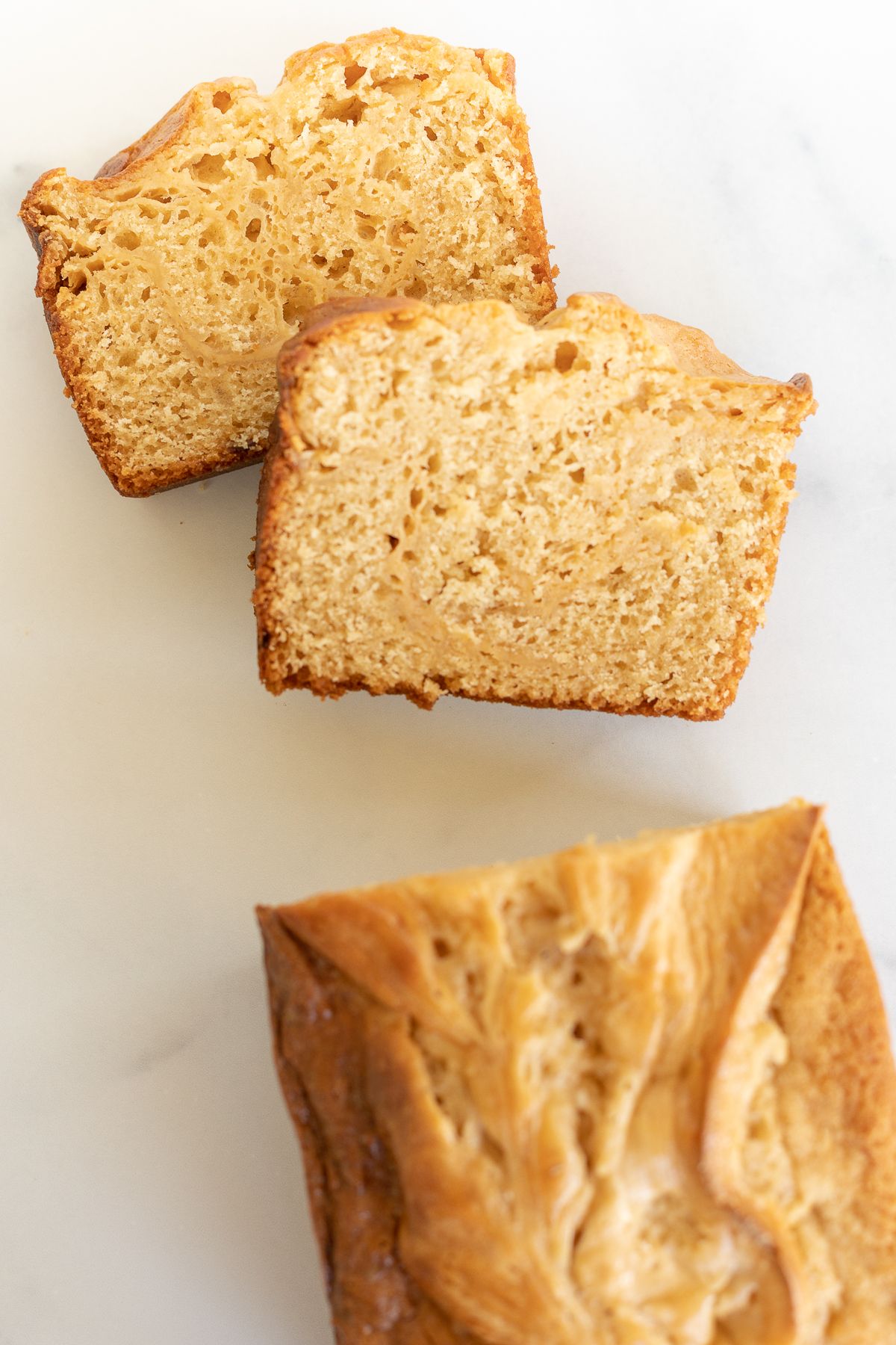 Sliced cream cheese bread with caramel, placed on a marble countertop