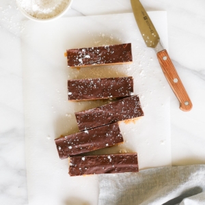 No bake cookie butter bars on a marble countertop, a knife for cutting them nearby.