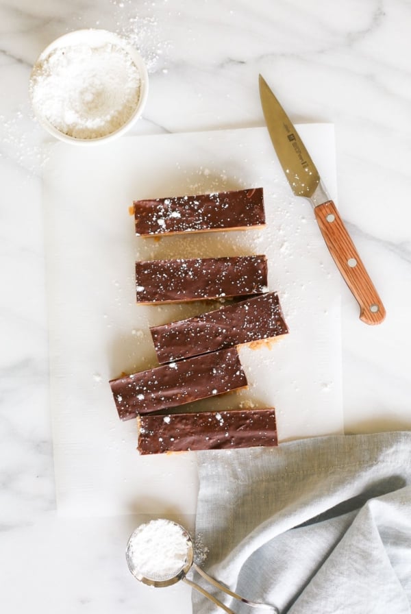 No bake cookie butter bars on a marble countertop, a knife for cutting them nearby.