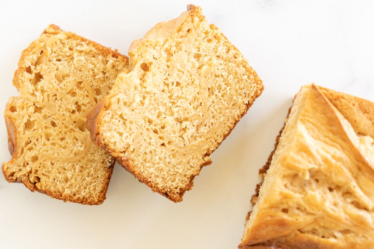 Sliced cream cheese bread with caramel, placed on a marble countertop