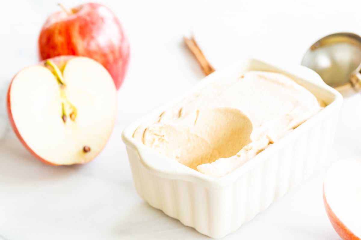 A bowl of apple ice cream with a spoon.