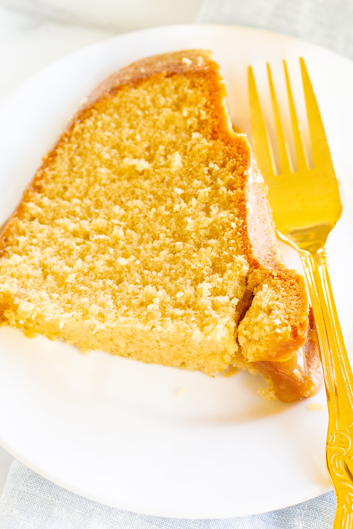 A slice of brown sugar caramel pound cake on a white plate