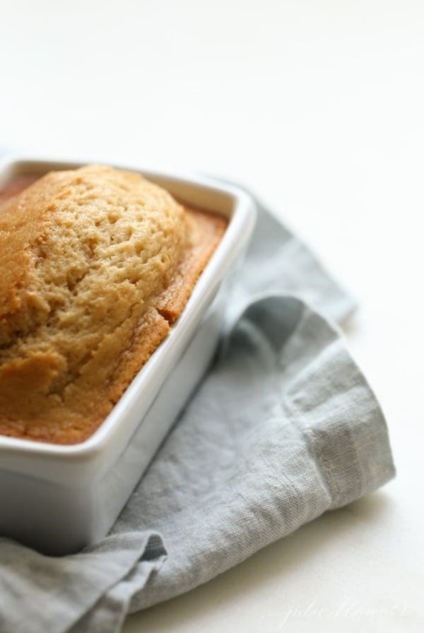 A small loaf of brown sugar bread, with a blue linen towel place underneath.