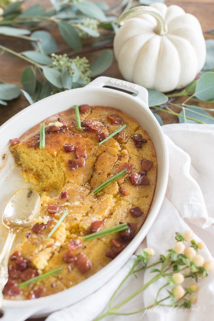 Cornbread in a casserole dish with a spoon