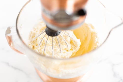 A mixer with cinnamon pound cake batter in the bowl.