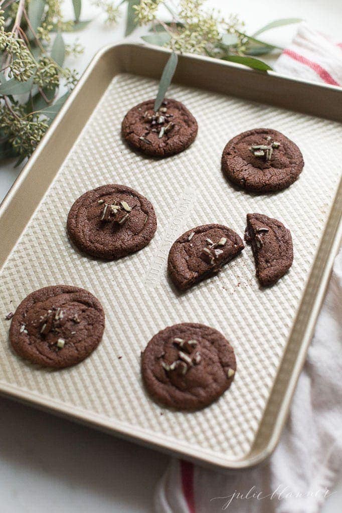 chewy chocolate mint cookies with andes candy on baking sheet