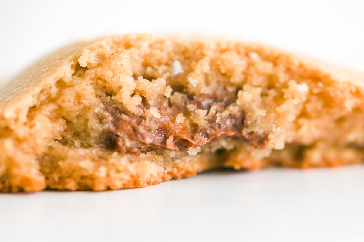 A stuffed peanut butter cookie with a bite taken out of it.