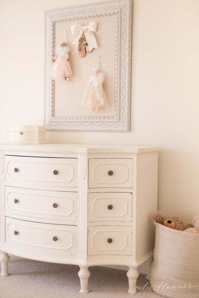 girls bedroom with a white dresser painted in Sherwin Williams Creamy