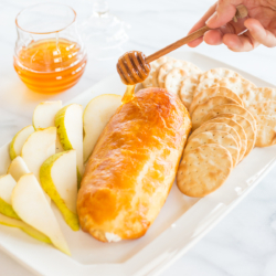 Baked goat cheese topped with honey with sliced pears.