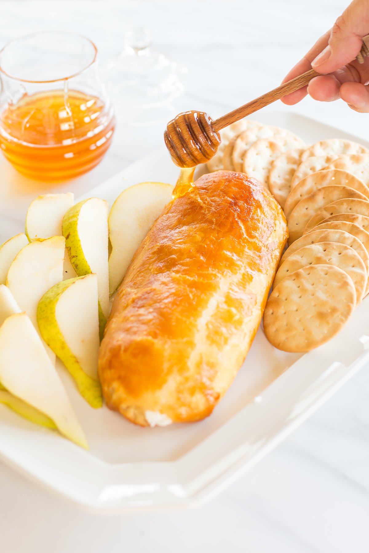 Baked goat cheese topped with honey with sliced pears.