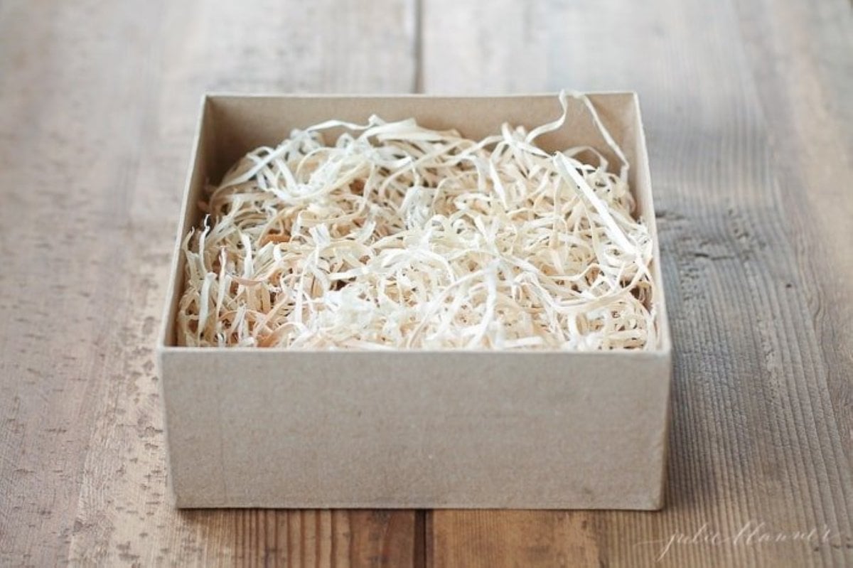 A brown kraft paper box filled with packaging materials