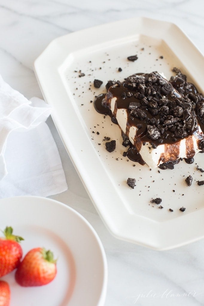 Chocolate cookies and cream cheese spread on a white plate