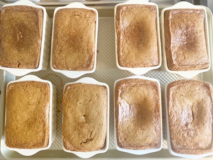 8 mini loaves of bread, baked in ceramic loaf pans, fallen in the center.