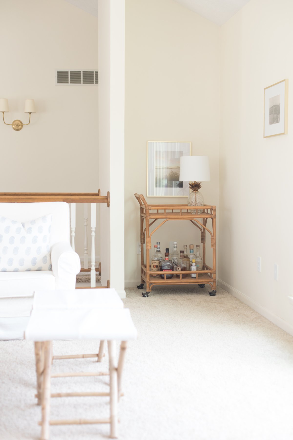 A white couch in a living room, with Farrow and Ball White Tie paint color on the walls.