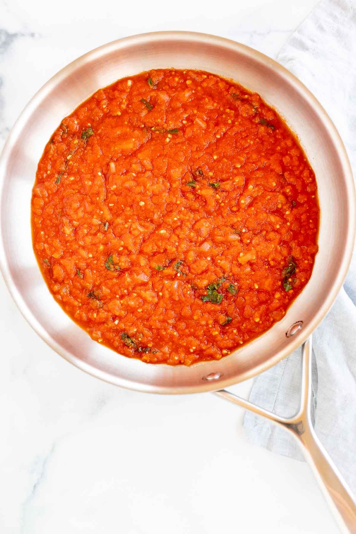 A silver saucepan full of pomodoro sauce