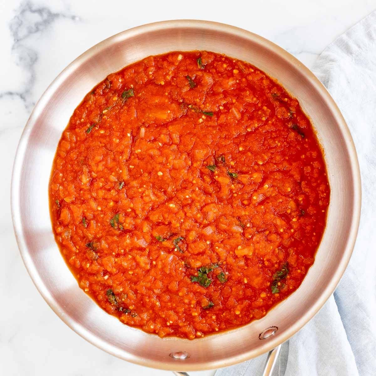 A silver saucepan full of pomodoro sauce