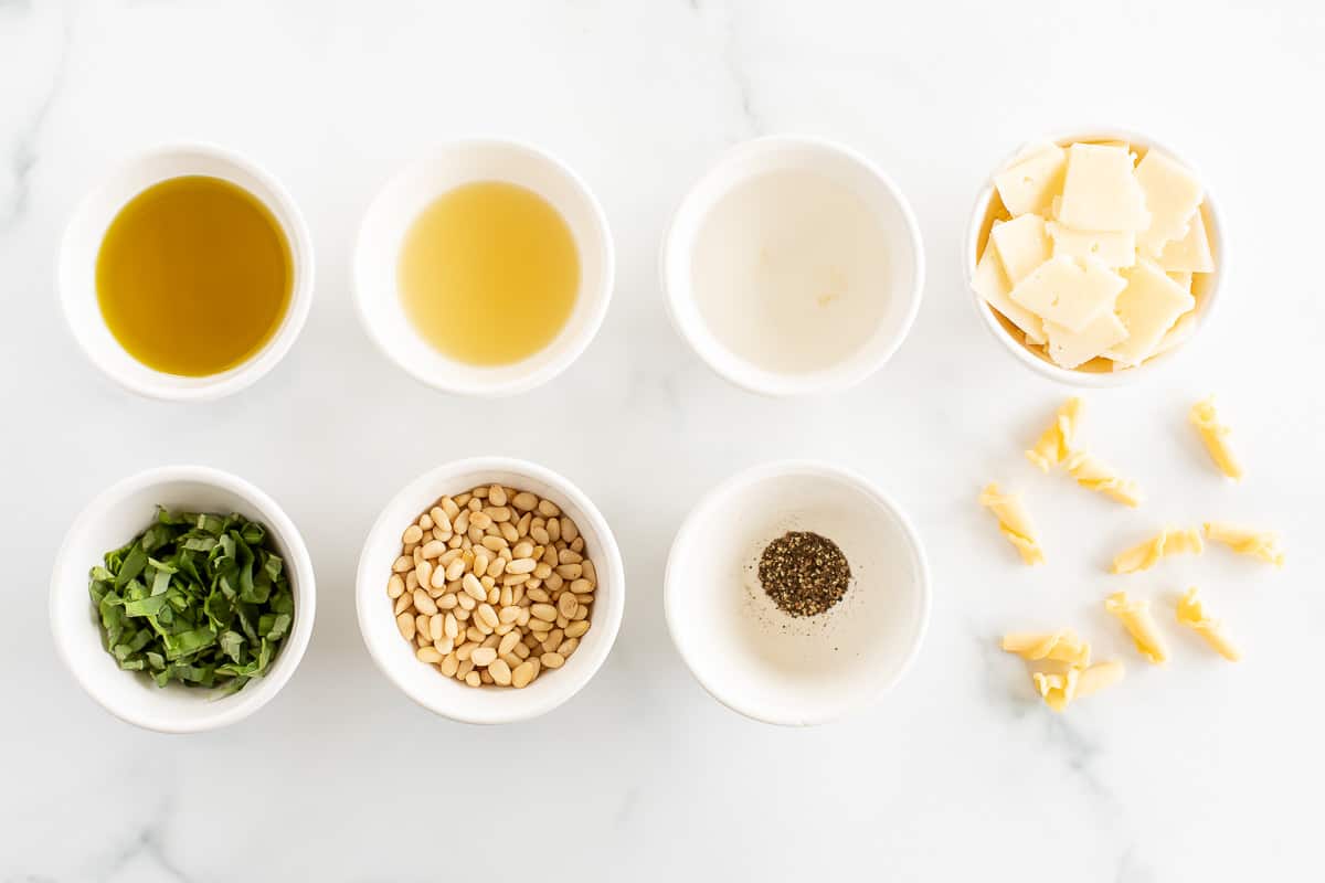 ingredients to make summer pasta salad in white bowls