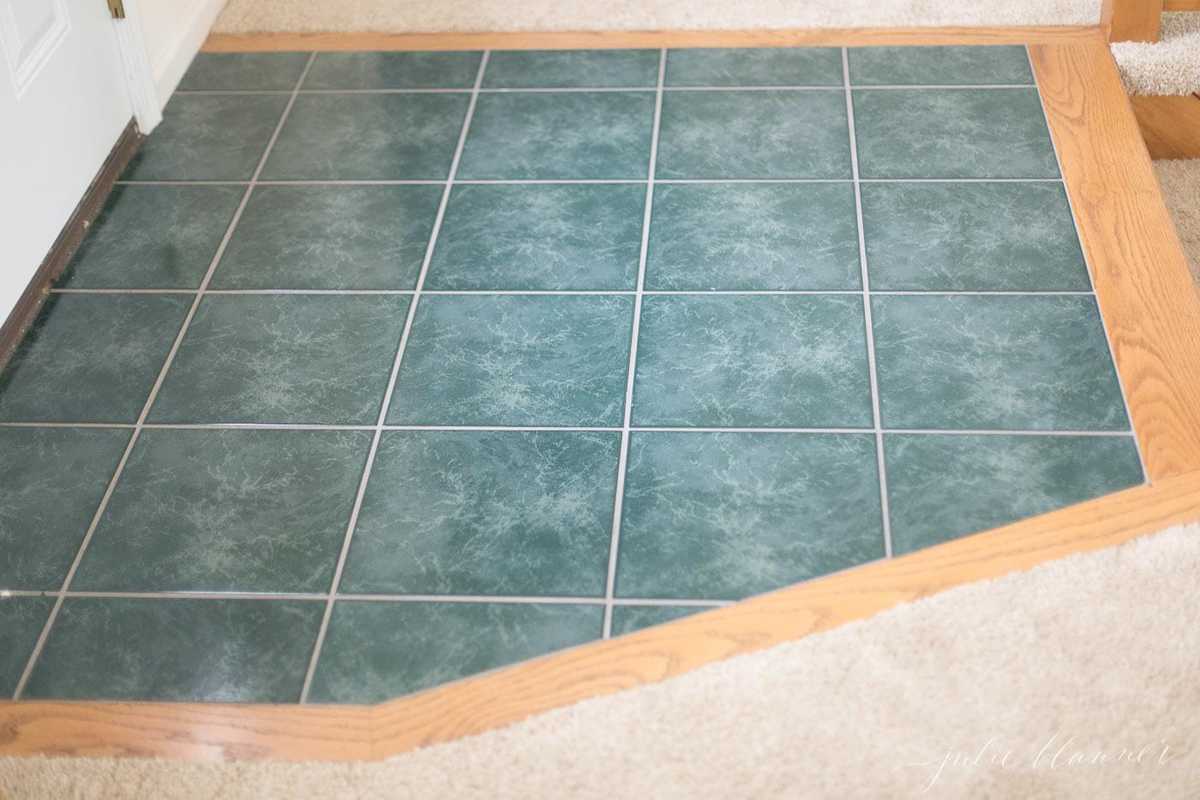 A green entryway floor in a 90s home