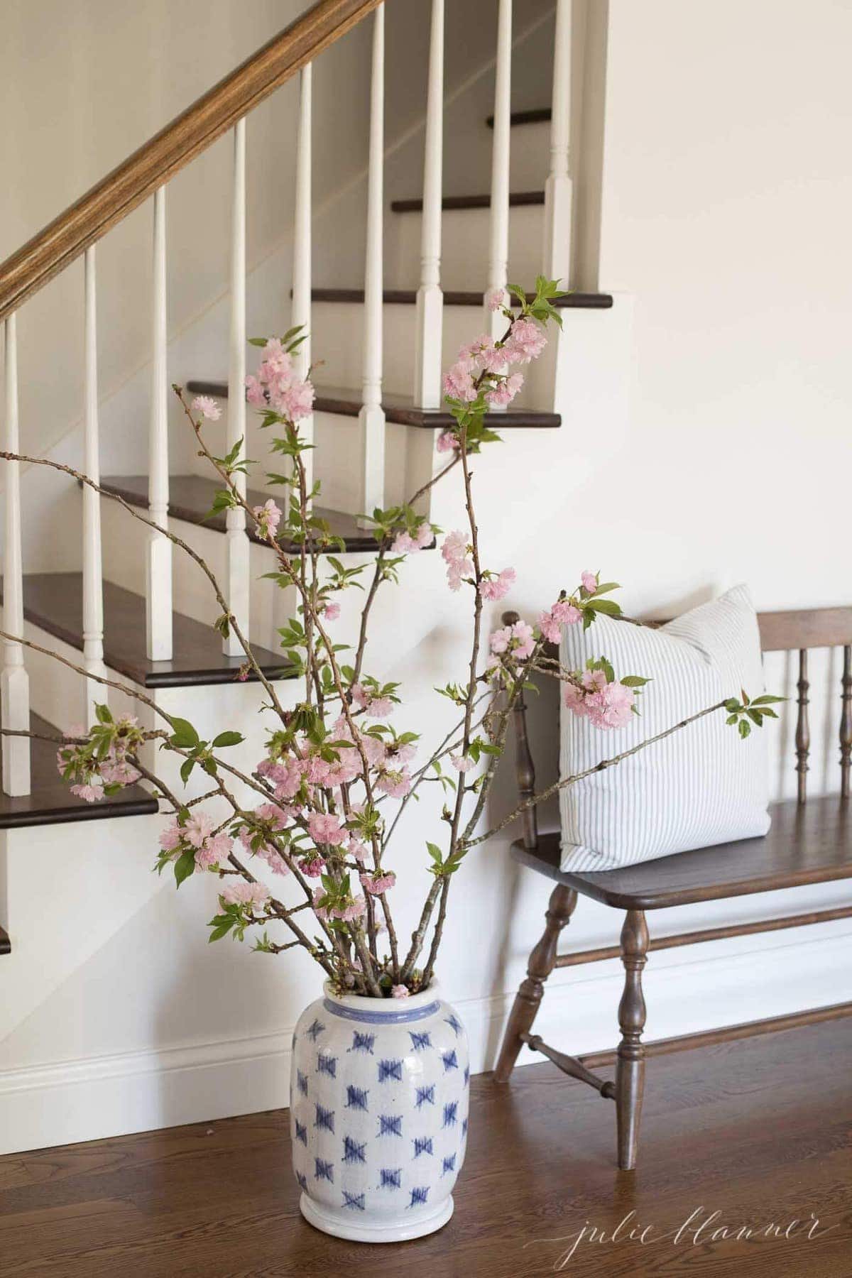 cherry blossom branches in blue and white patterned vase