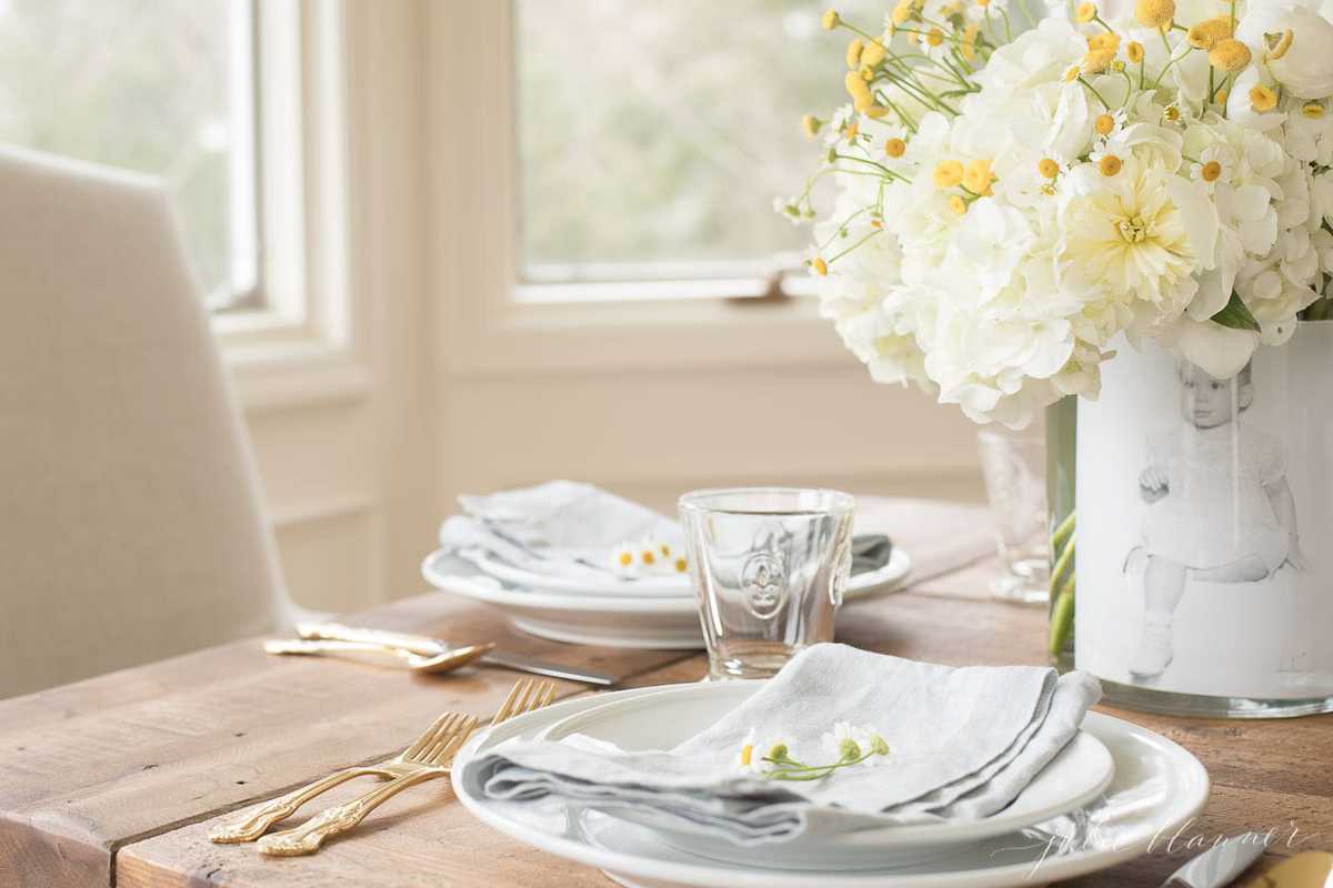 Mother's day decor idea of a photo vase filled with flowers on a mother's day brunch table.