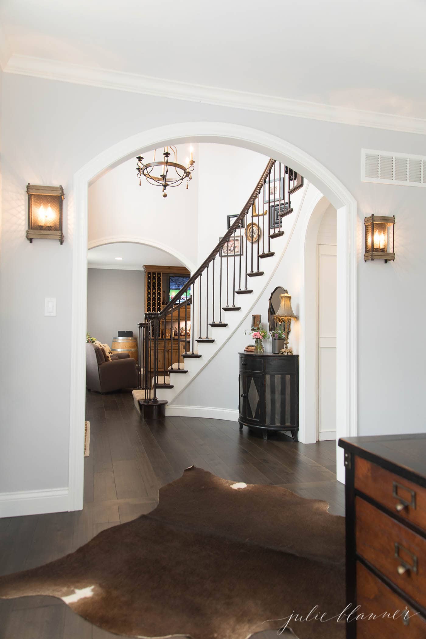 modern colonial staircase and arched opening