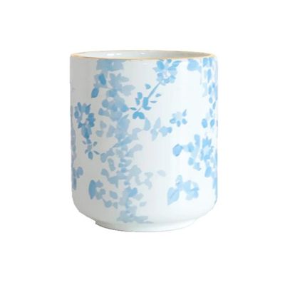 A blue and white flower vase on a white background.