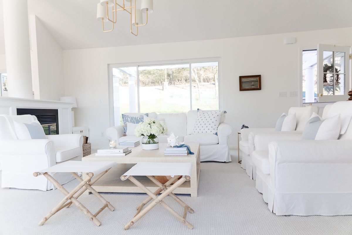 A white living room with white sofas and coastal decor