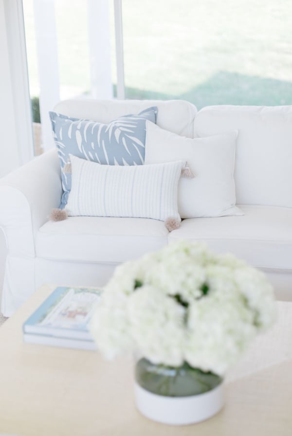 A white living room with white sofas and coastal decor