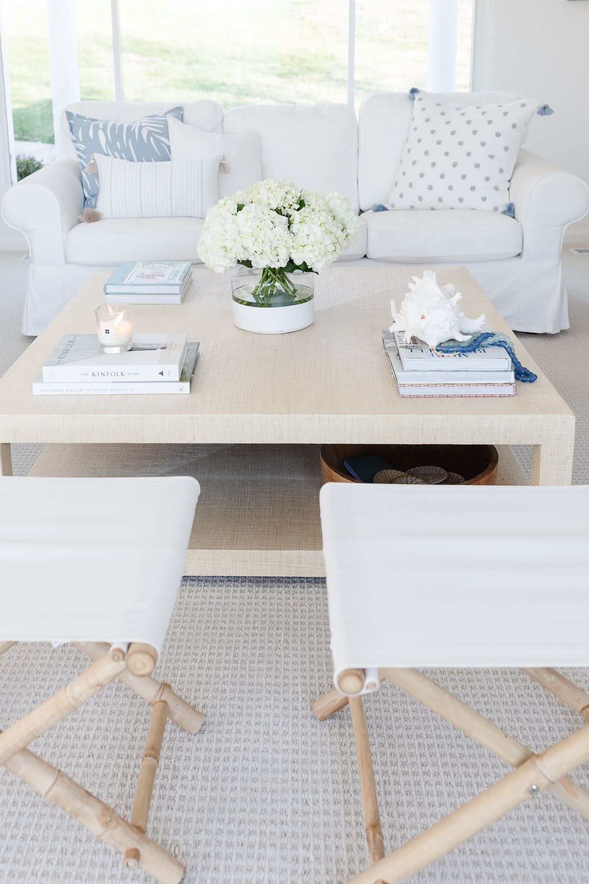 A white living room with white sofas and coastal decor