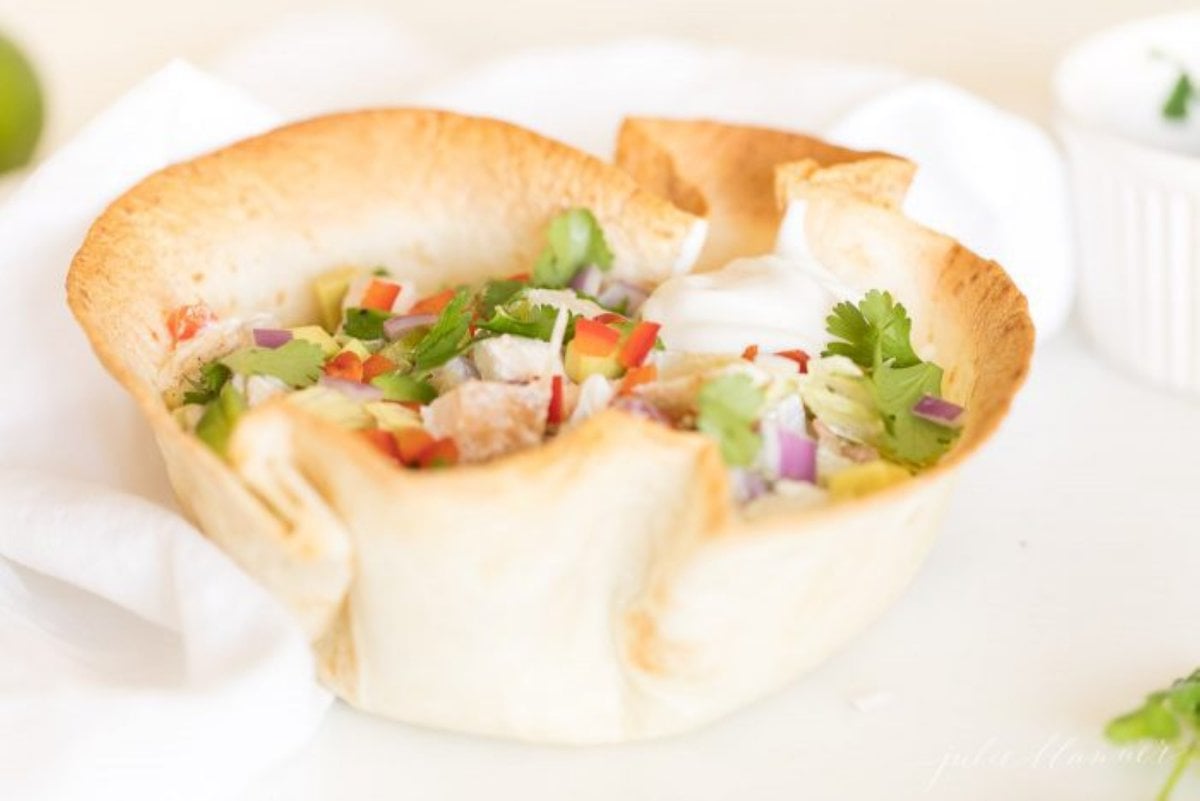 A taco salad in a homemade taco bowl shell.