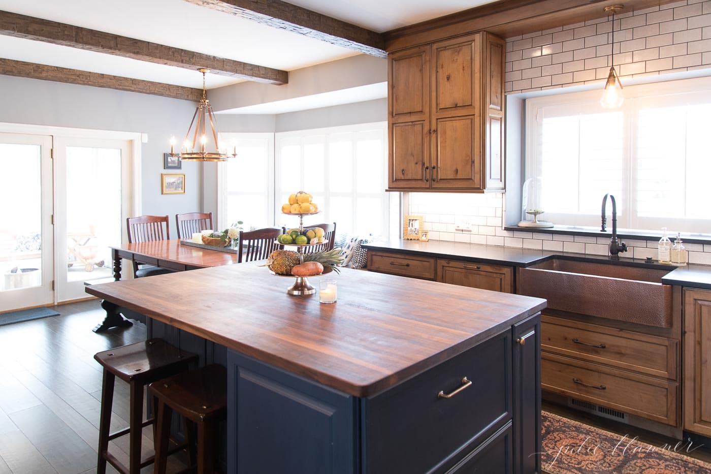 navy blue island and wood cabinets