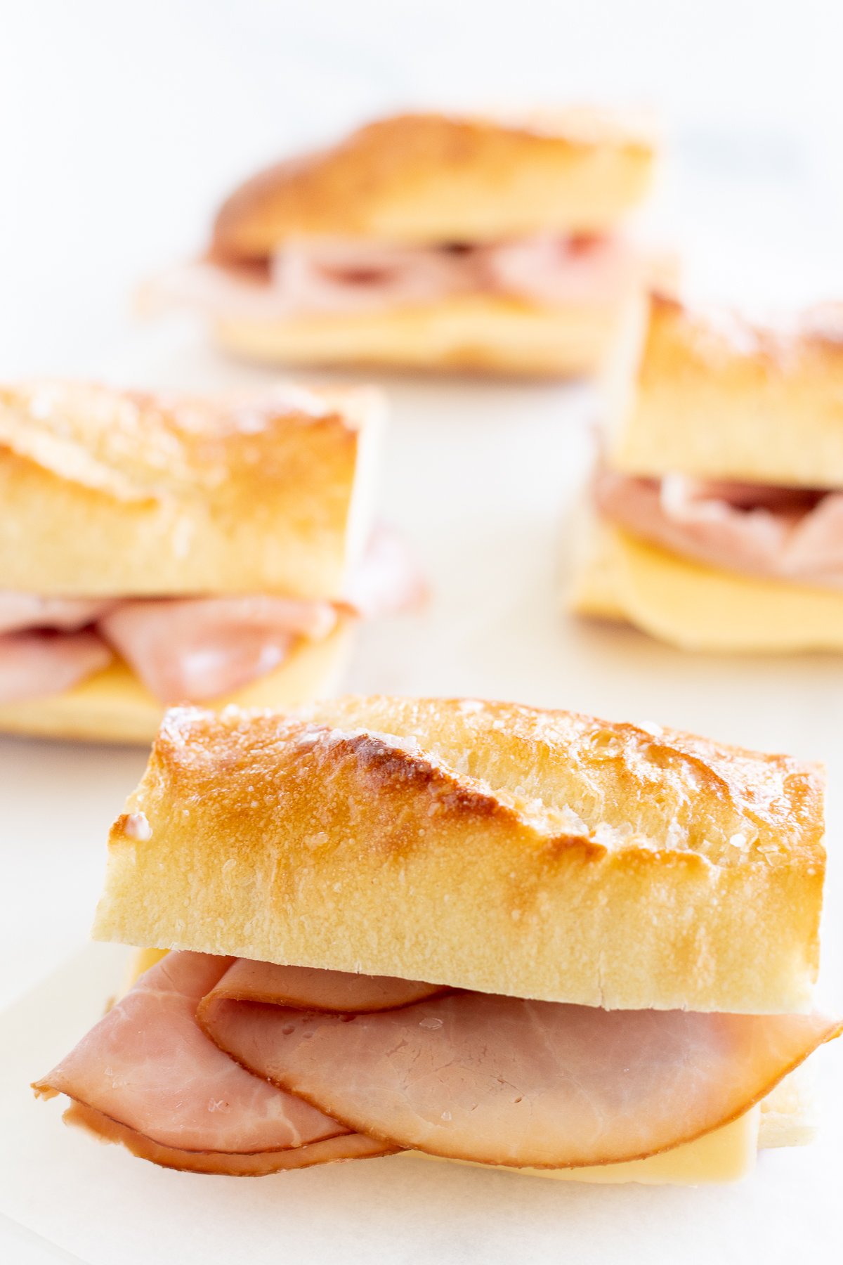 Picnic sandwiches on a white surface.