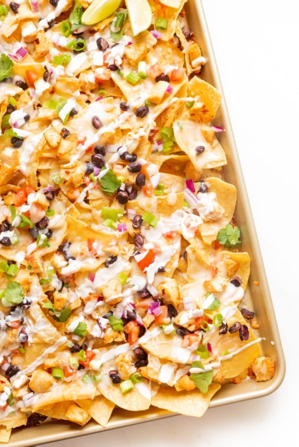 Chicken nachos on a sheet pan.