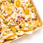 Chicken nachos on a sheet pan.
