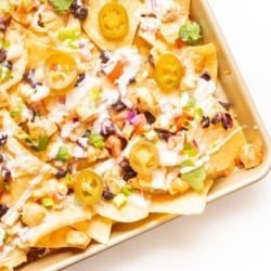 Chicken nachos on a sheet pan.