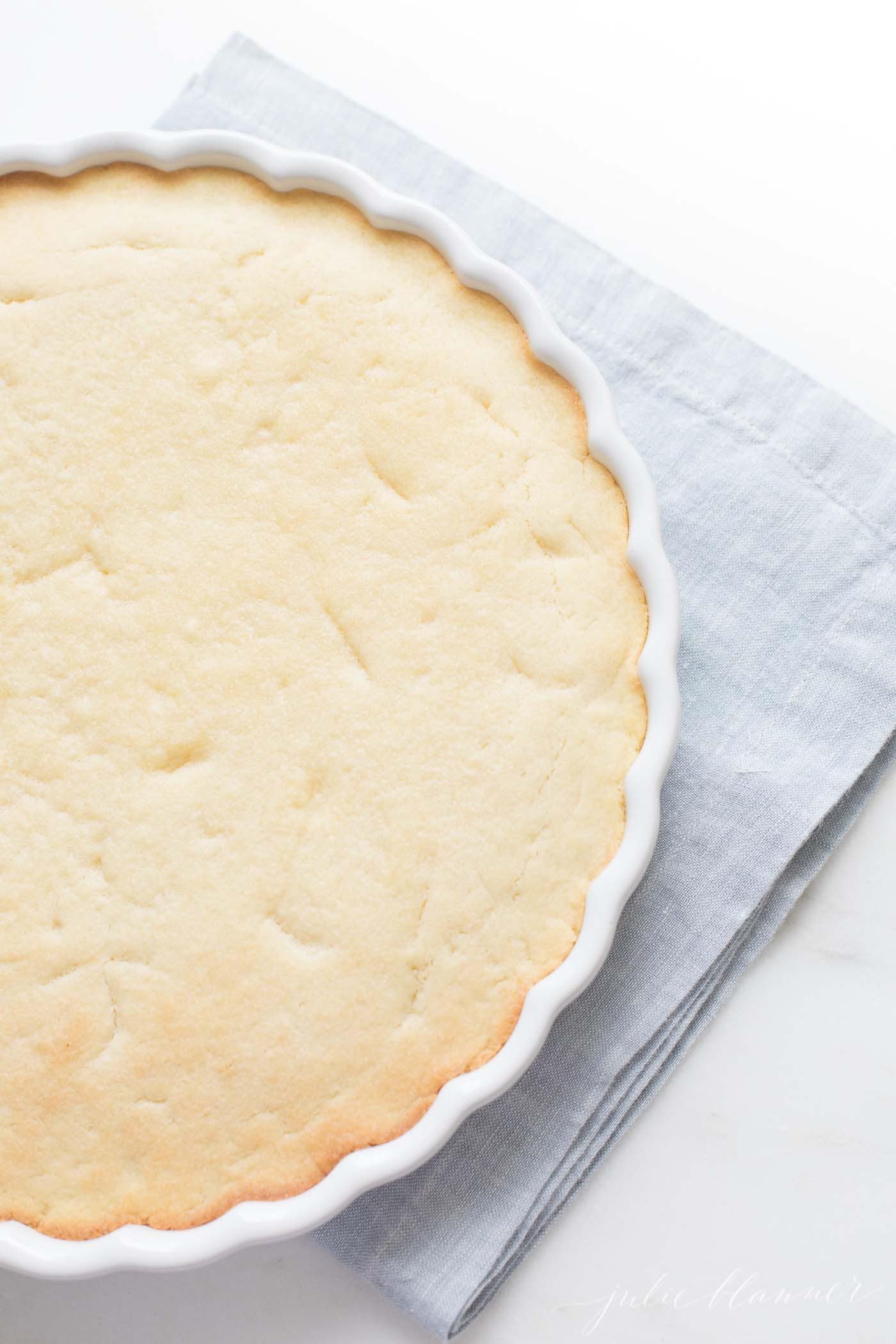 sugar cookie crust in a white pie dish