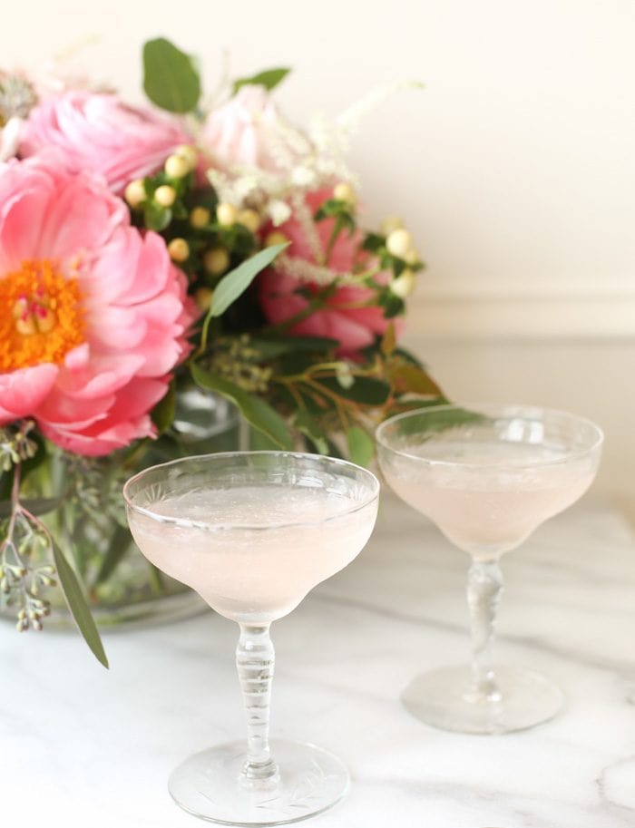 two glasses of frose by flowers