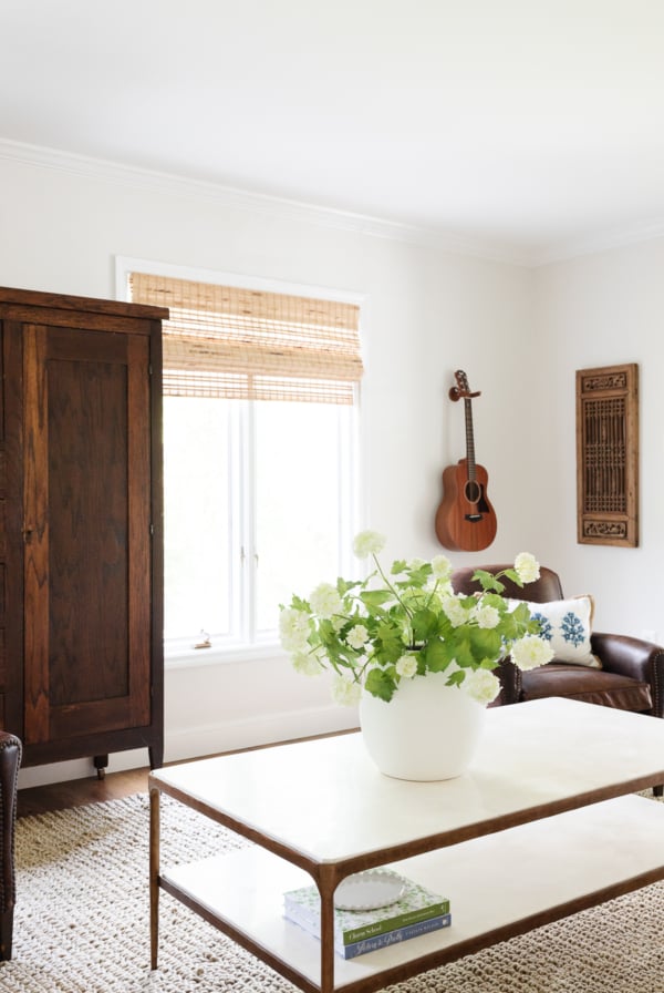 A living room with a white table and chairs, featuring a pet-friendly rug.