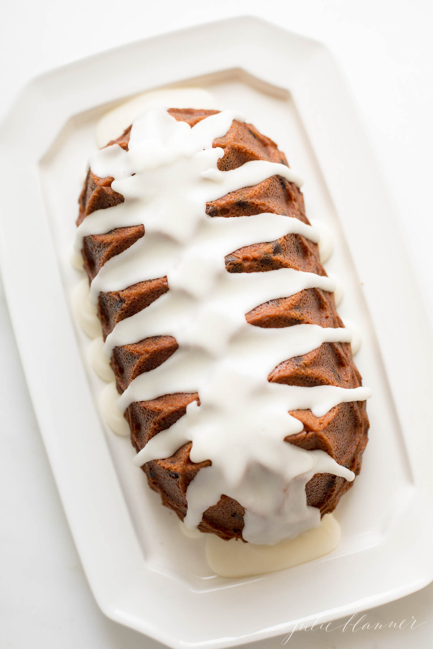 chocolate chip pound cake shaped in a decorative loaf, on a white platter