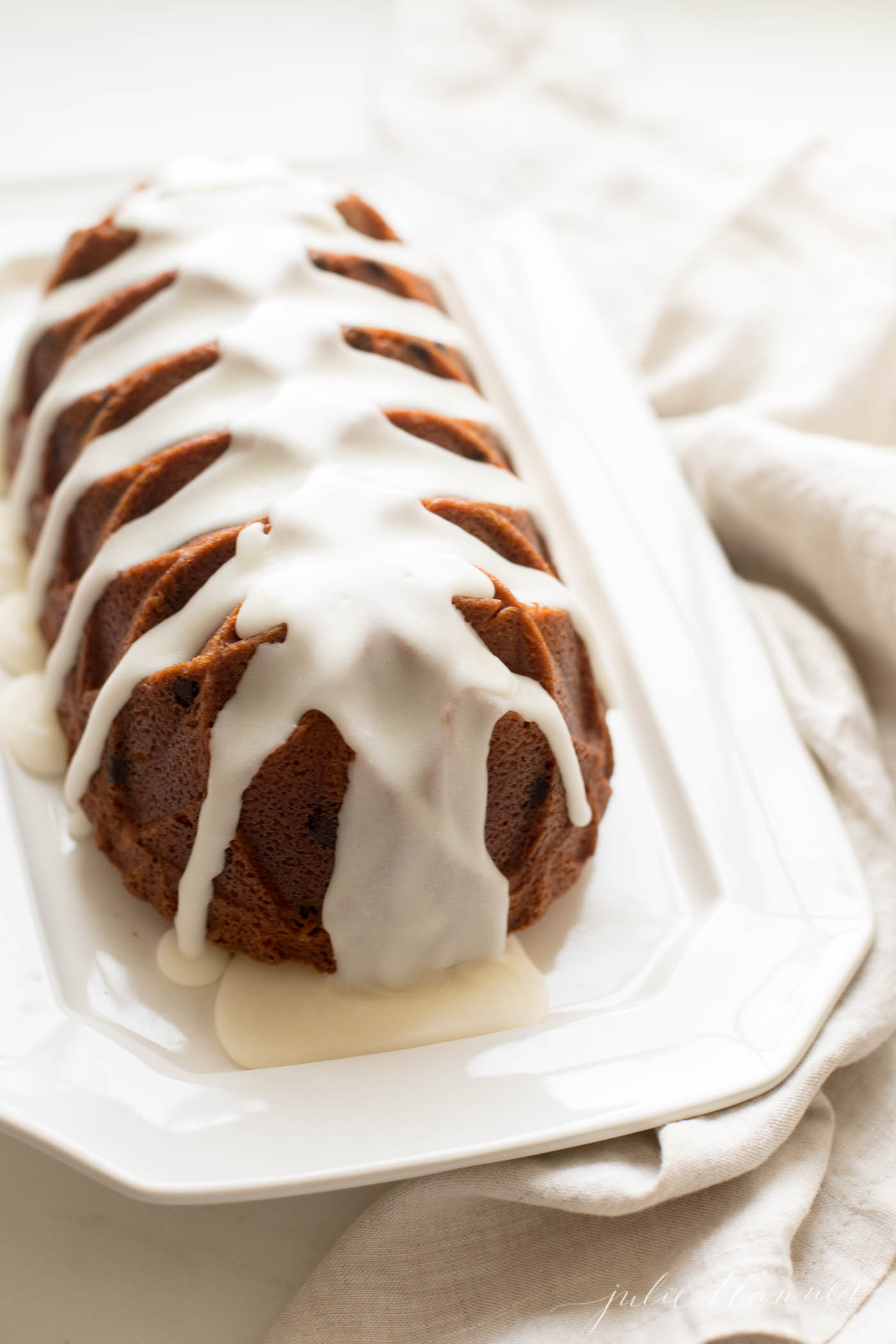 chocolate chip pound cake shaped in a decorative loaf, on a white platter