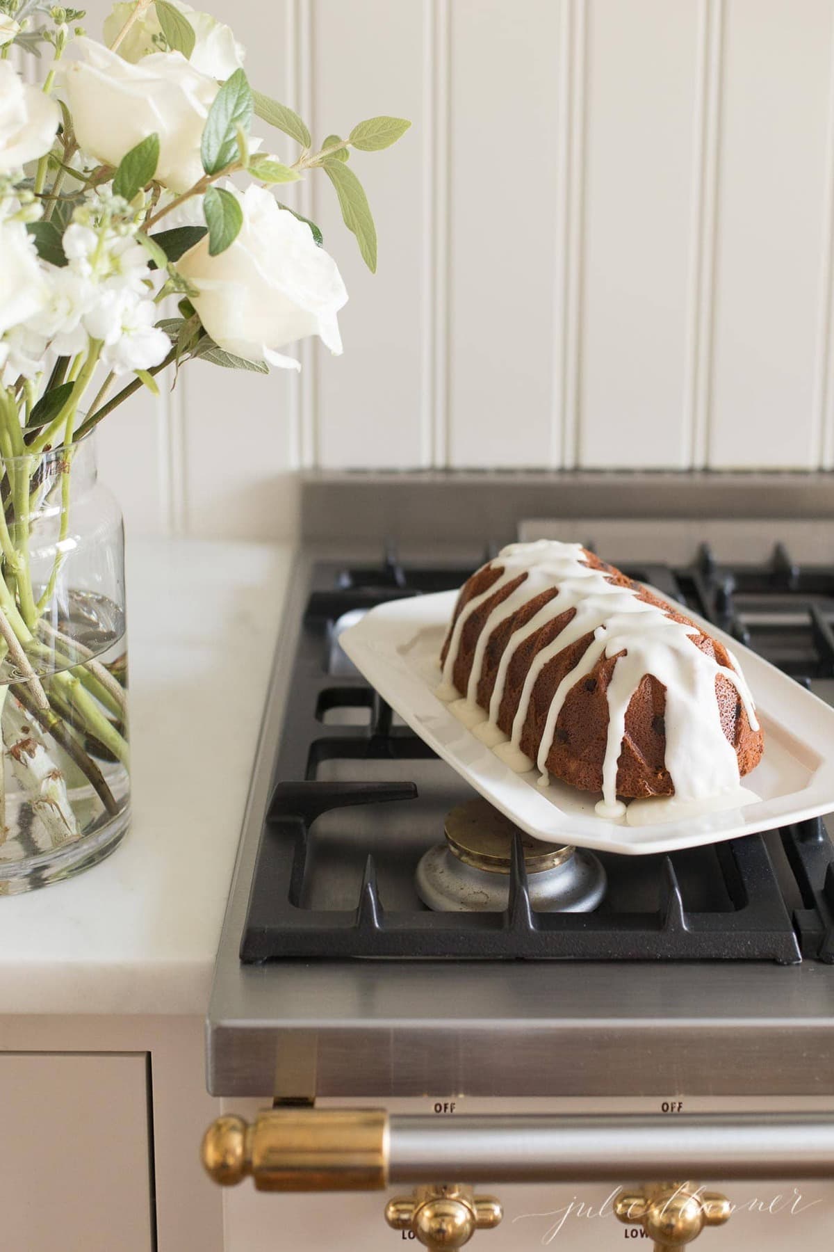 chocolate chip pound cake shaped in a decorative loaf, on a white platter