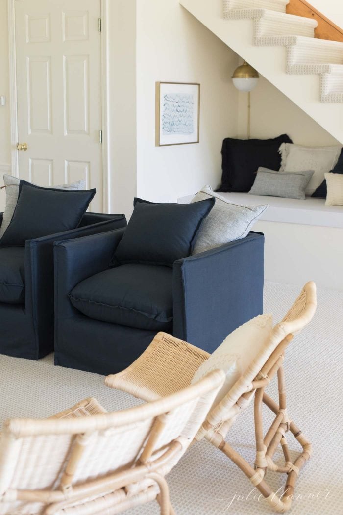 A modern living room with navy accents. 