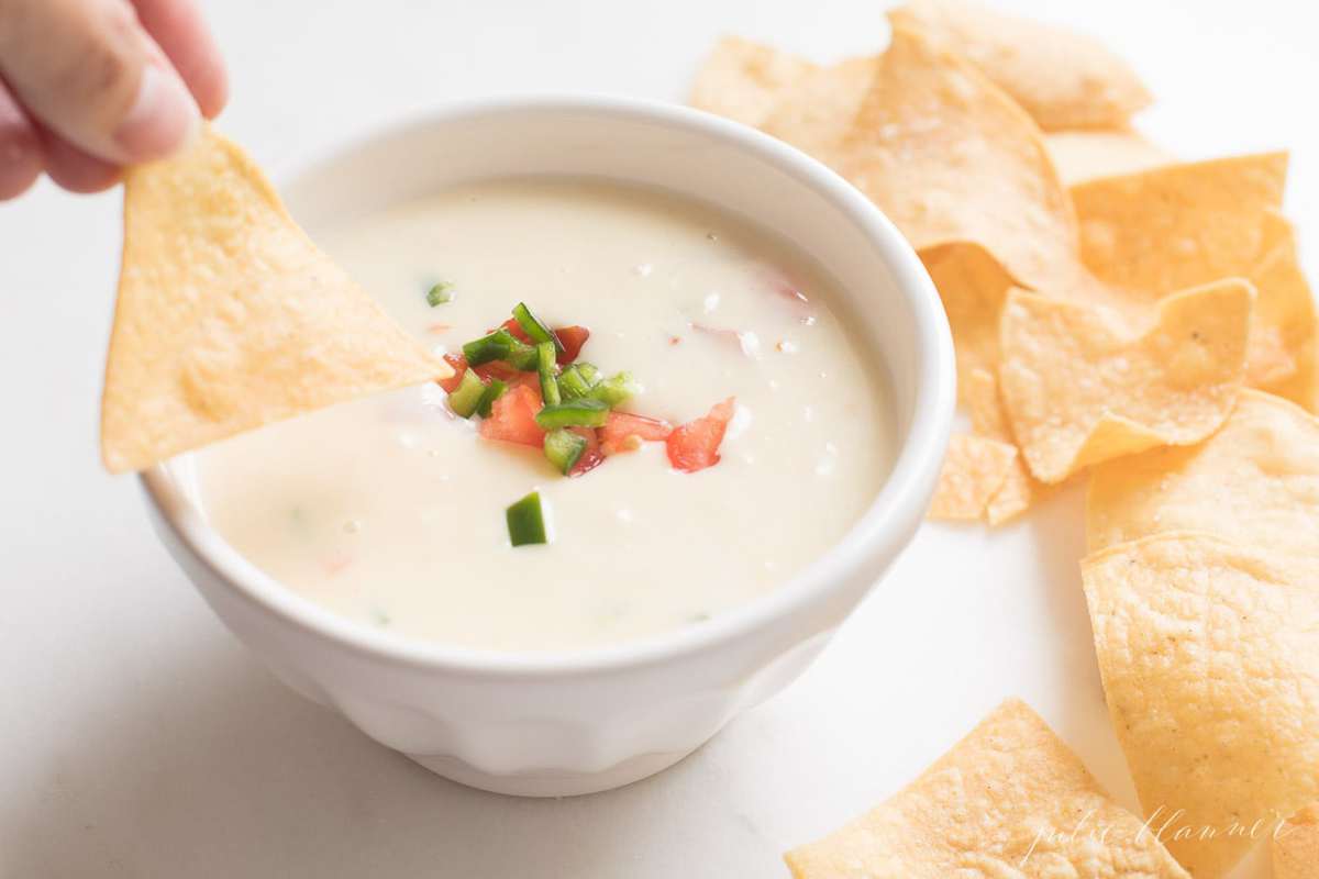 queso blanco in a white bowl with tortilla chips