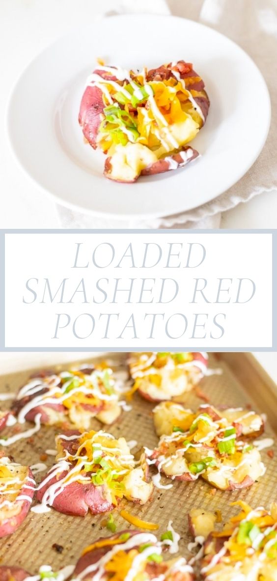 On a marble counter top, there is a round white plate and a golden baking sheet of loaded smashed red potatoes.