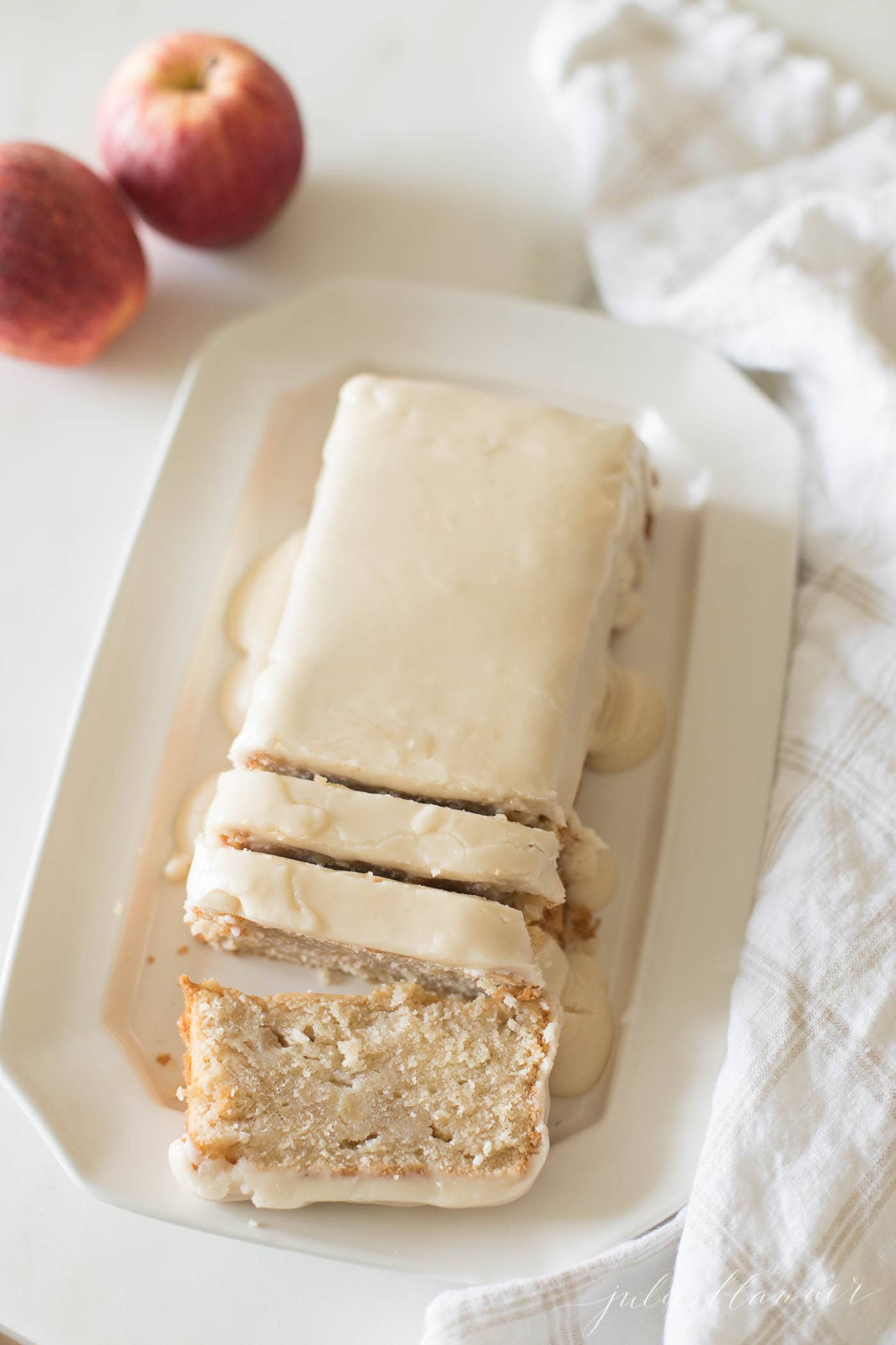 apple pound cake sliced on a white platter