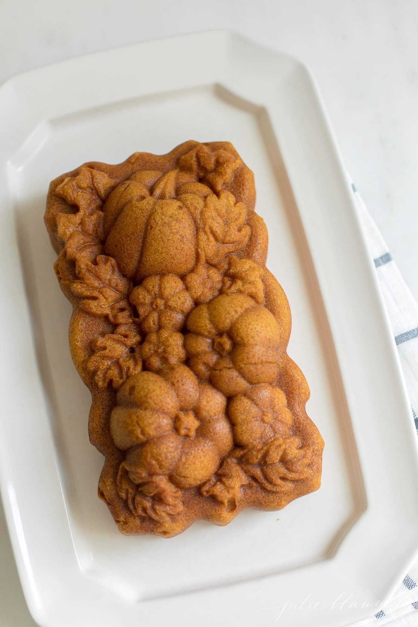 A cake with pumpkin design on a white plate