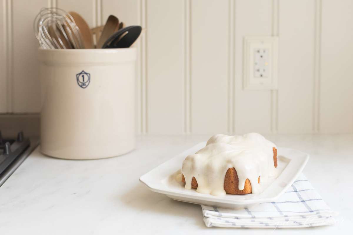 pumpkin pound cake with cream cheese glaze on kitchen countertop