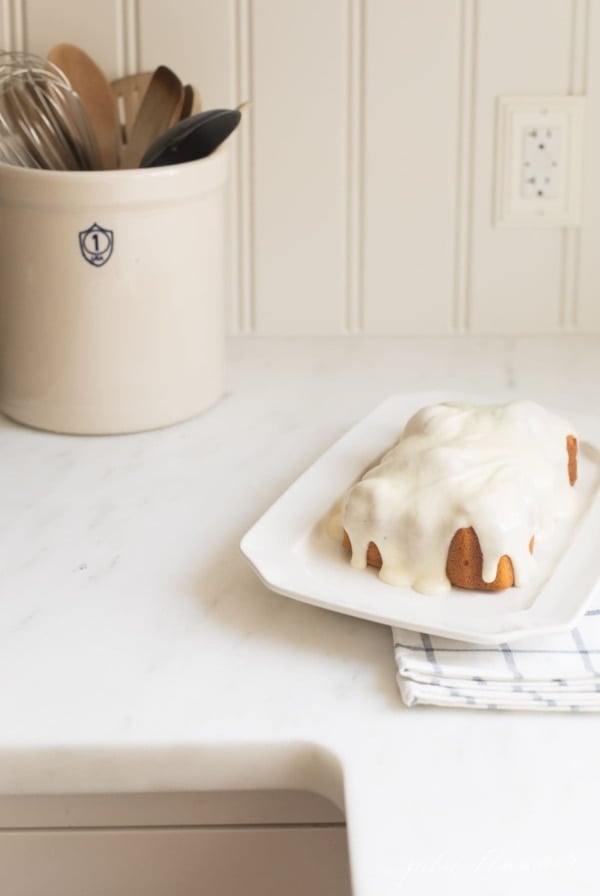 pumpkin pound cake on counter next to crock